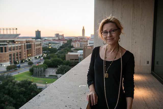 Elizabeth Crook stands on the balcony of the LBJ Presidential Library